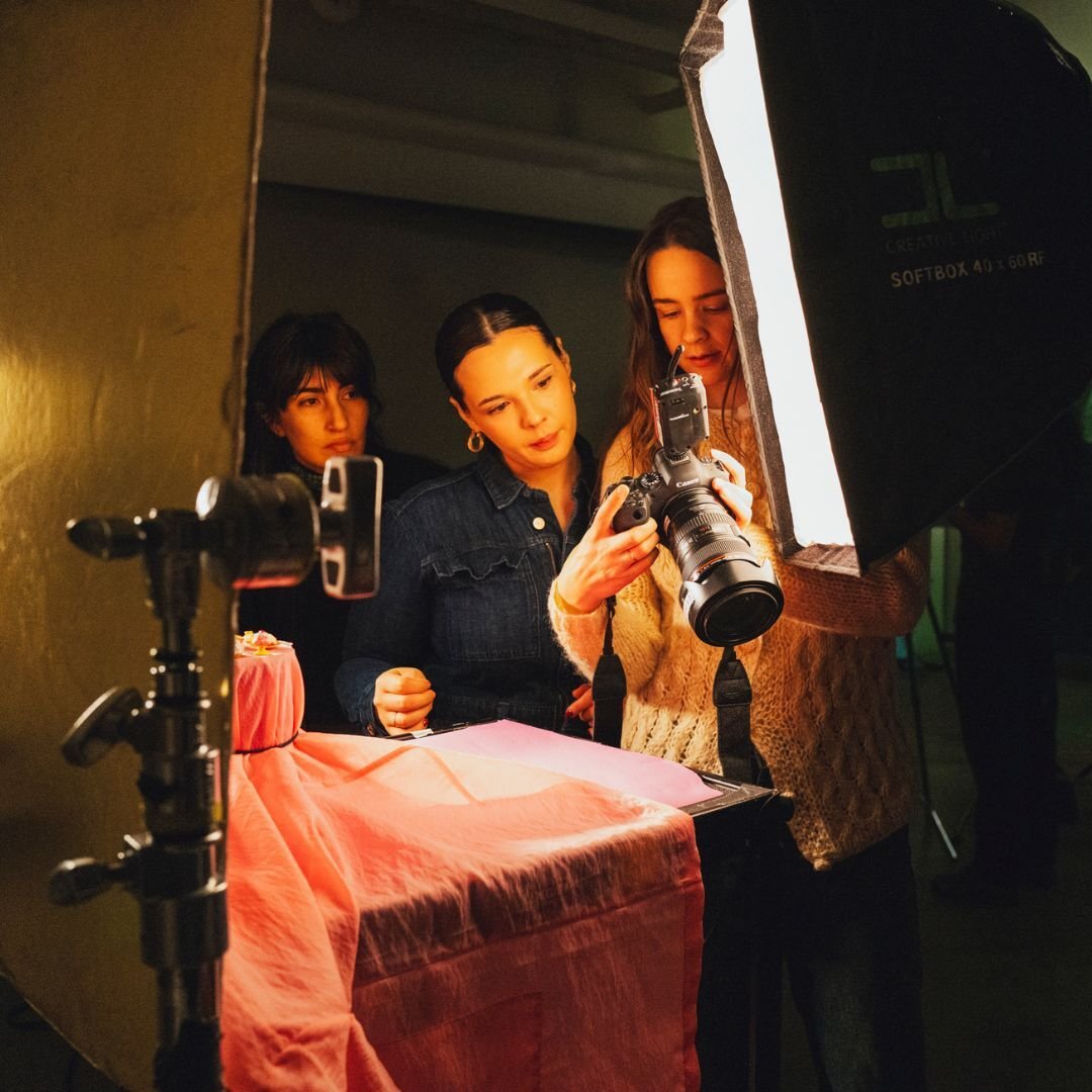 Three students working in a lighting studio